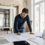 Maitre d'oeuvre coordonnant un projet de travaux avec des plans