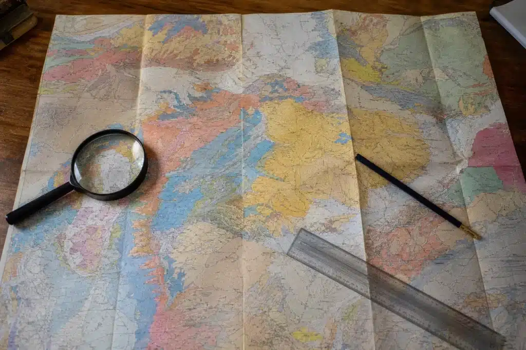 Carte de zonage des argiles consultée à la loupe sur un bureau