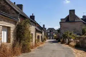 Rue de village en Mayenne après une sécheresse, mairie au fond
